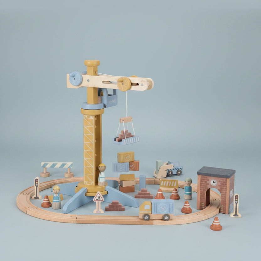 Wooden toy railway set with various pieces on a white background