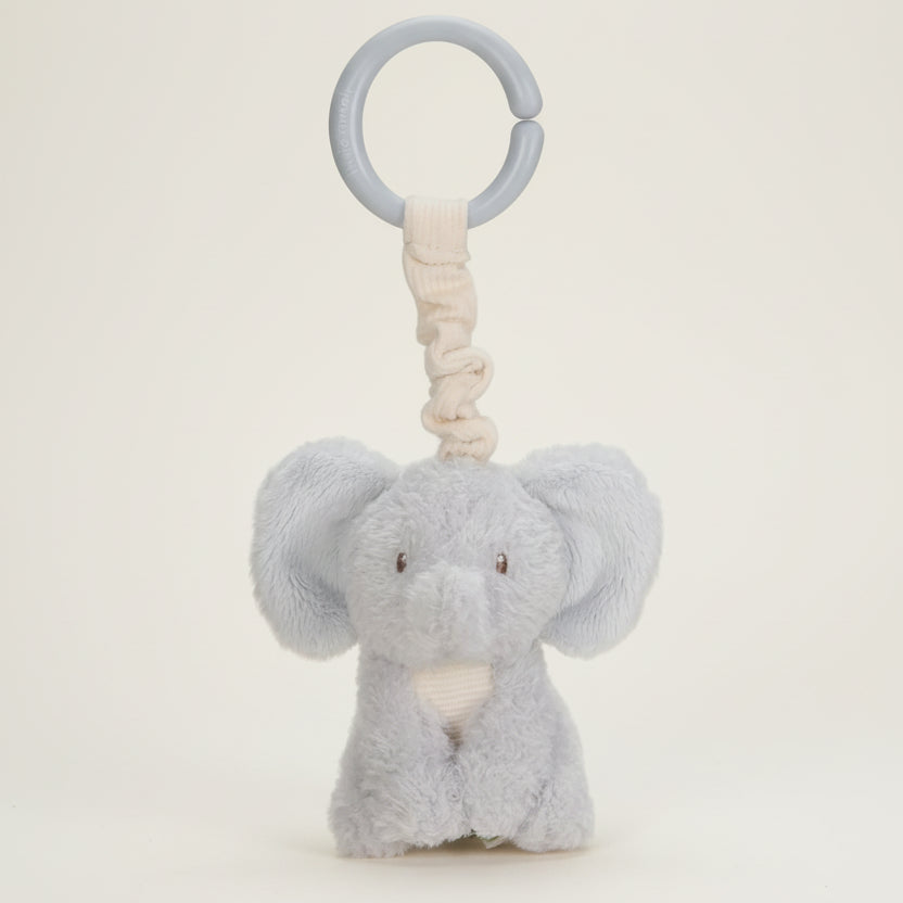 Plush elephant toy with a ring on a white background