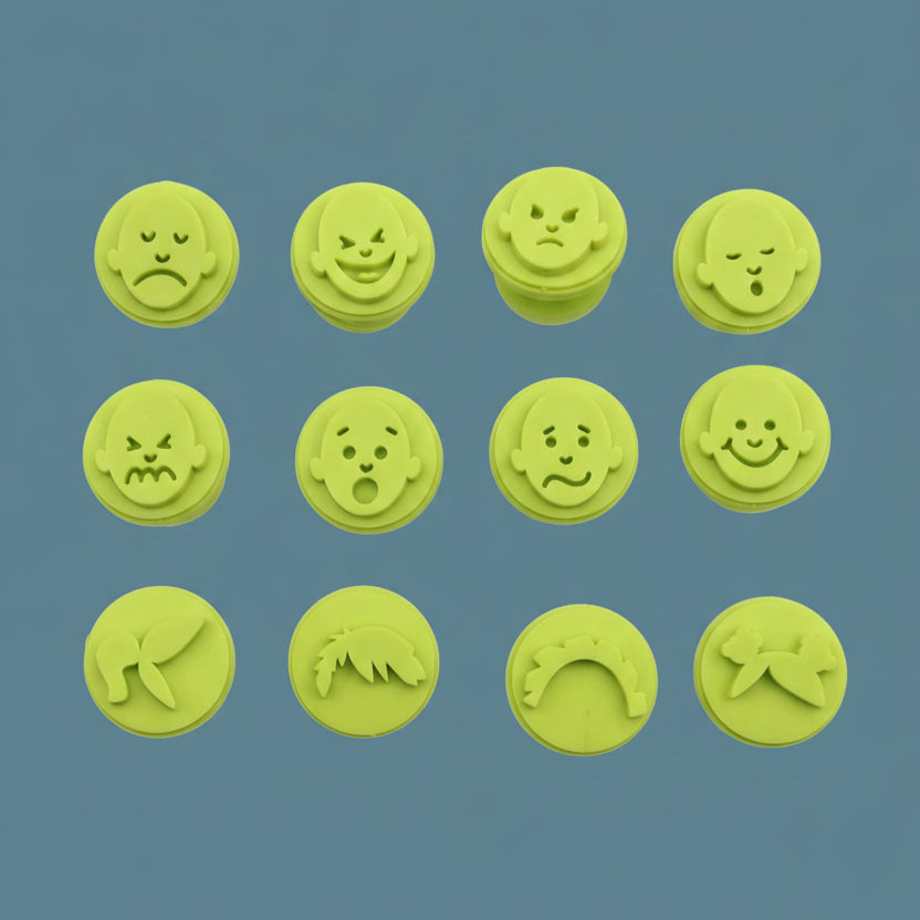 Emotion face stampers used with colourful paint on paper for arts and crafts activity.