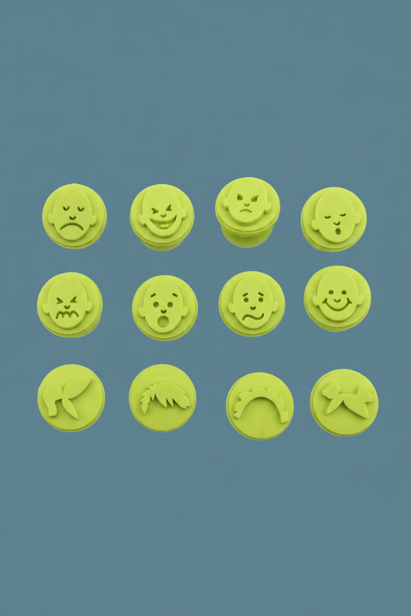 Emotion face stampers used with colourful paint on paper for arts and crafts activity.