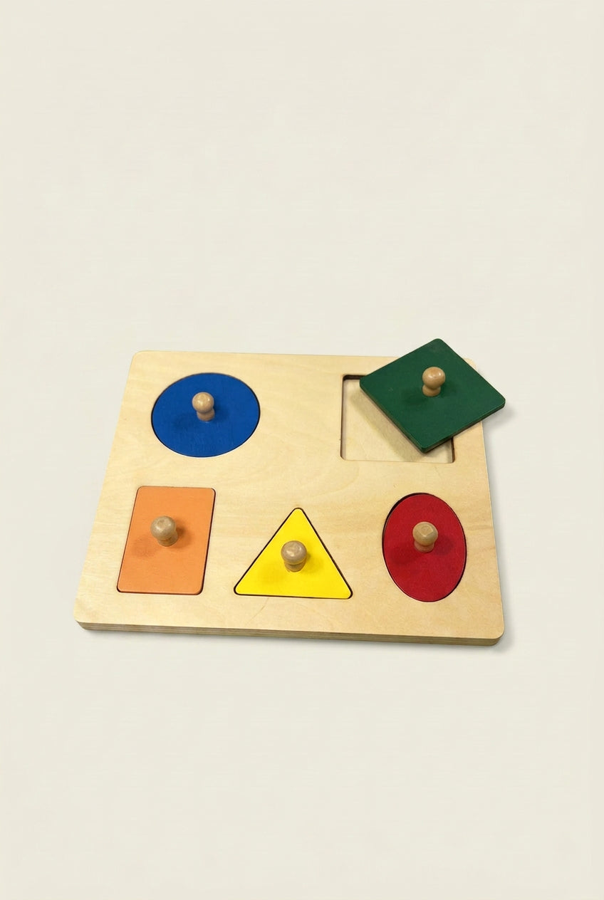 Wooden shape sorting puzzle with colorful shapes on a green background