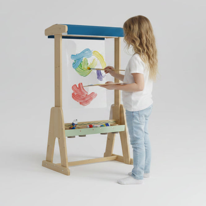 Child painting on an outdoor perspex easel