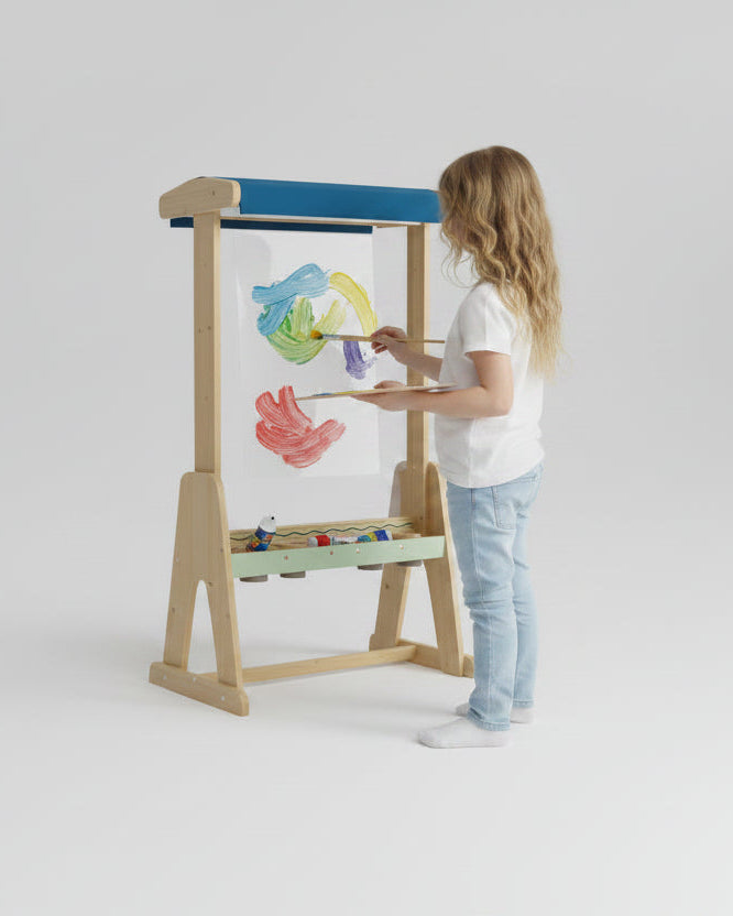 Child painting on an outdoor perspex easel