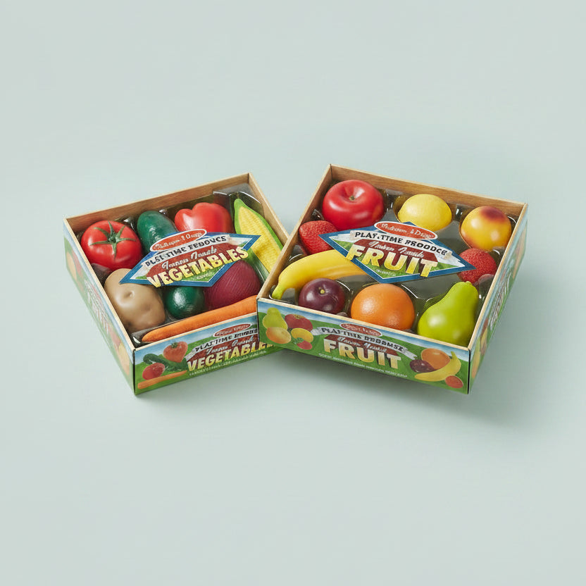 Two boxes of toy fruits and vegetables with colorful packaging on a white background.