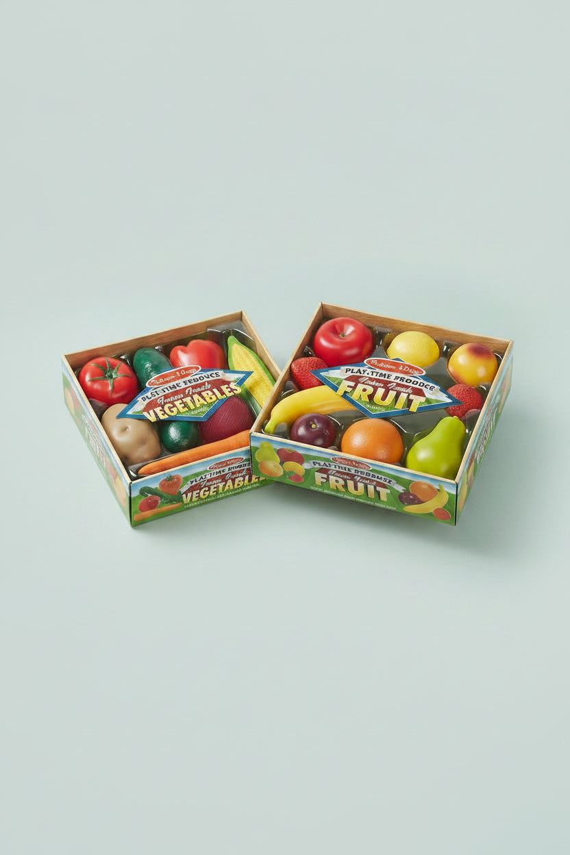 Two boxes of toy fruits and vegetables with colorful packaging on a white background.