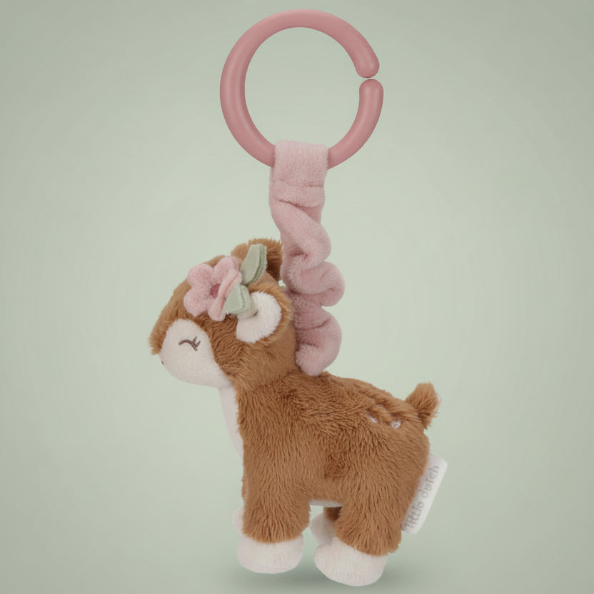 Plush deer toy with pink rattle on a white background