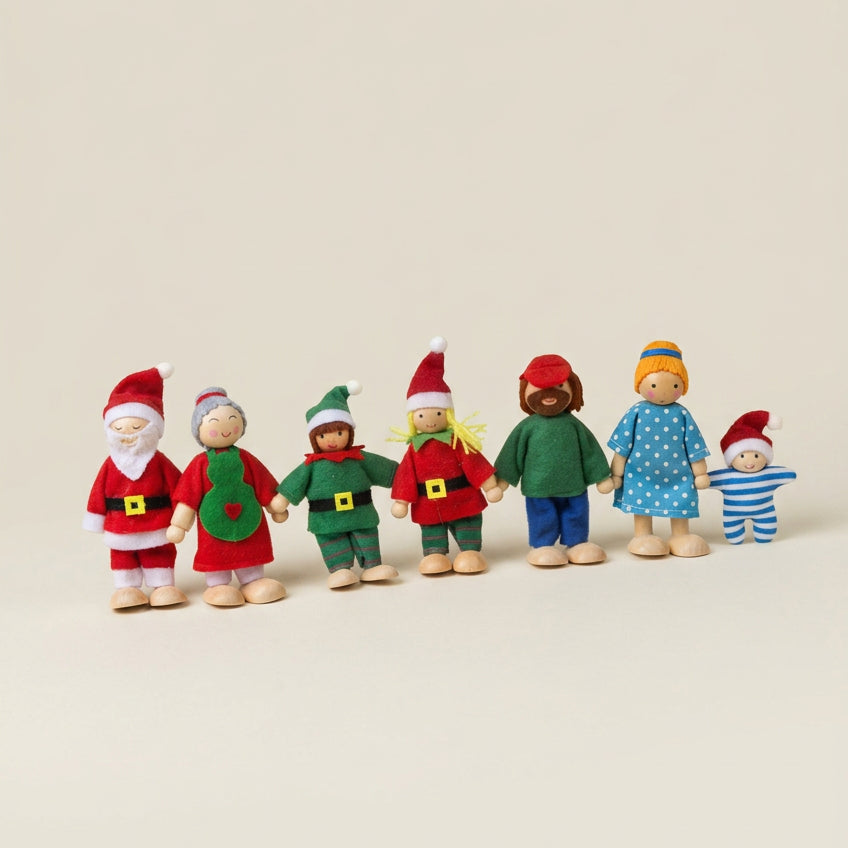 A set of seven wooden family dolls in Christmas attire, positioned against a neutral background.