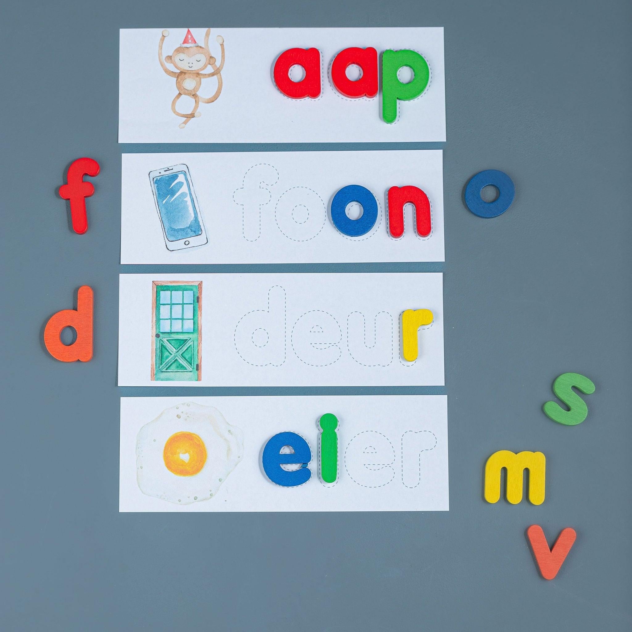 Kids building words with wooden alphabet letters