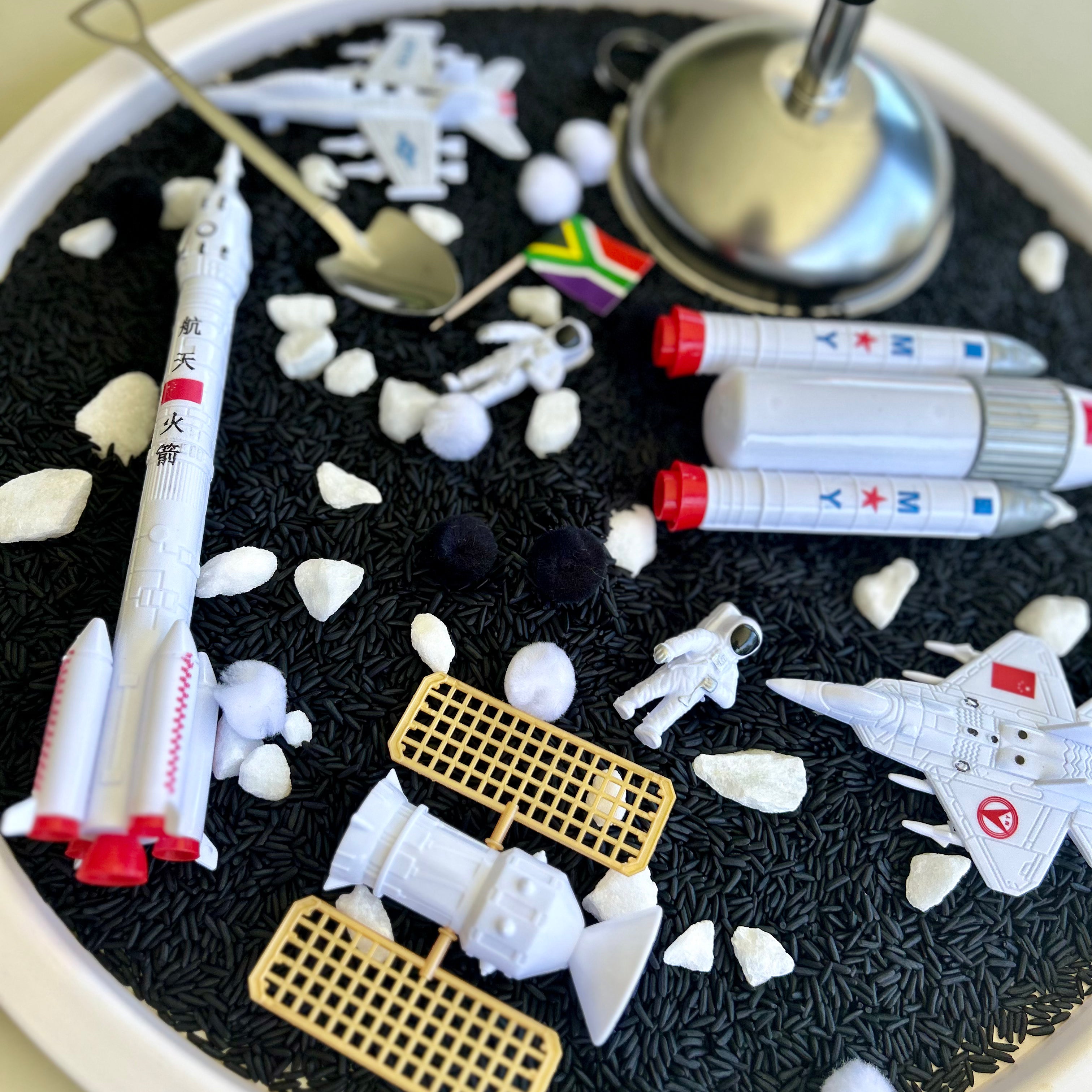 Moonlanding sensory set with black rice, astronaut figurines and metal tools for imaginative and sensory play
