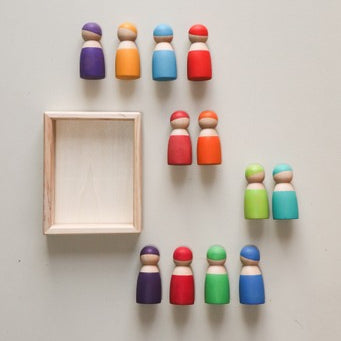 painted peg dolls around a wooden tray