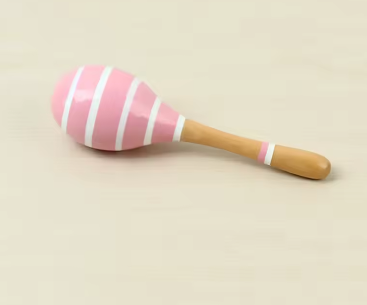 A collection of colorful wooden maracas, each hand-painted with non-toxic, child-safe paints. The maracas come in various colors and patterns, displayed against a white background.
