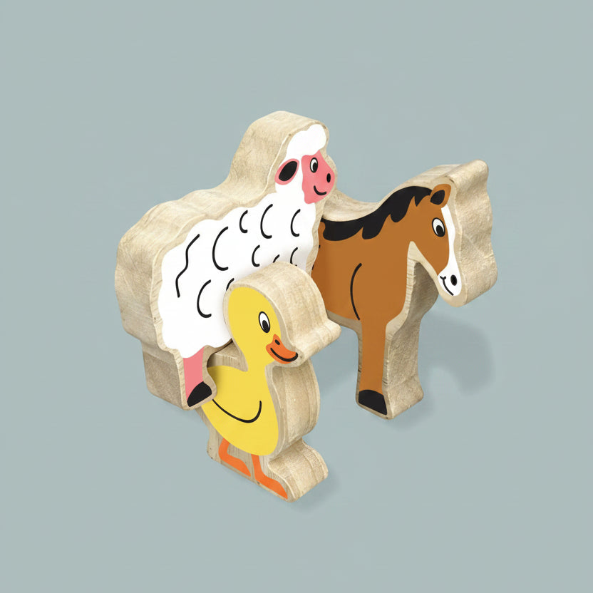 Wooden farm animal toy set featuring a sheep, duck, and horse with printed faces, shown on a blue background with dimension callouts indicating 85mm height and 15mm thickness.