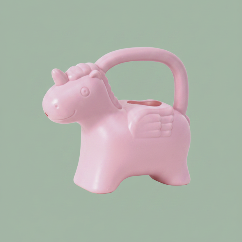 A light pink watering can shaped like a winged unicorn with a carrying handle, shown on a plain white background.