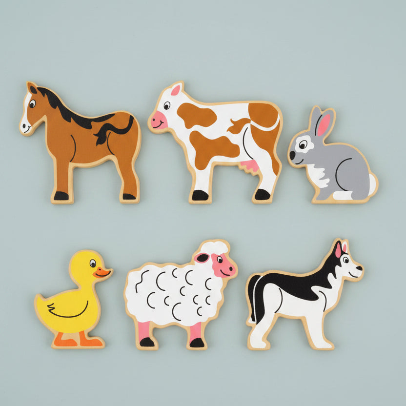 Six farm animal wooden on a blue background: a brown horse, a brown-and-white cow, a gray rabbit, a yellow duck, a white sheep, and a black-and-white dog.