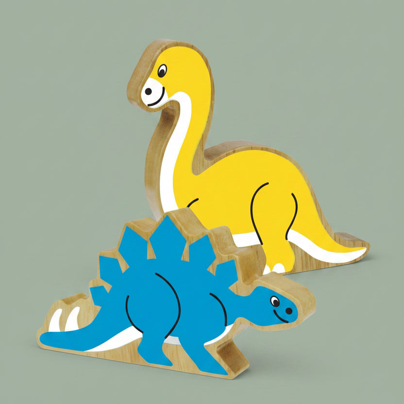 Two wooden dinosaur toy blocks, one yellow long-neck dinosaur and one blue Stegosaurus, shown on a plain white background.