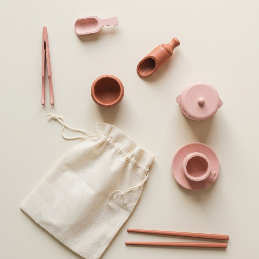 Wooden sensory tool set with lidded pot, cup, plate, bowl, two scoops, tweezers and two sticks arranged on a white background – Tiny Tree Toys South Africa