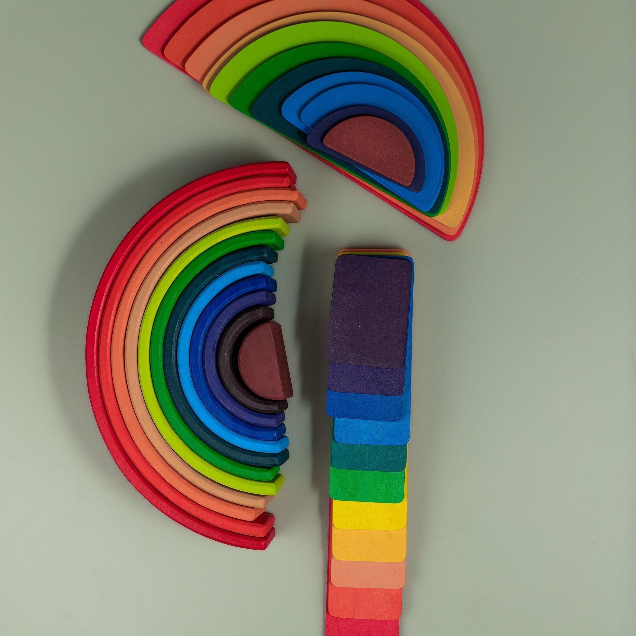Full rainbow stacker set showing arches, strips, and semi-circle pieces together