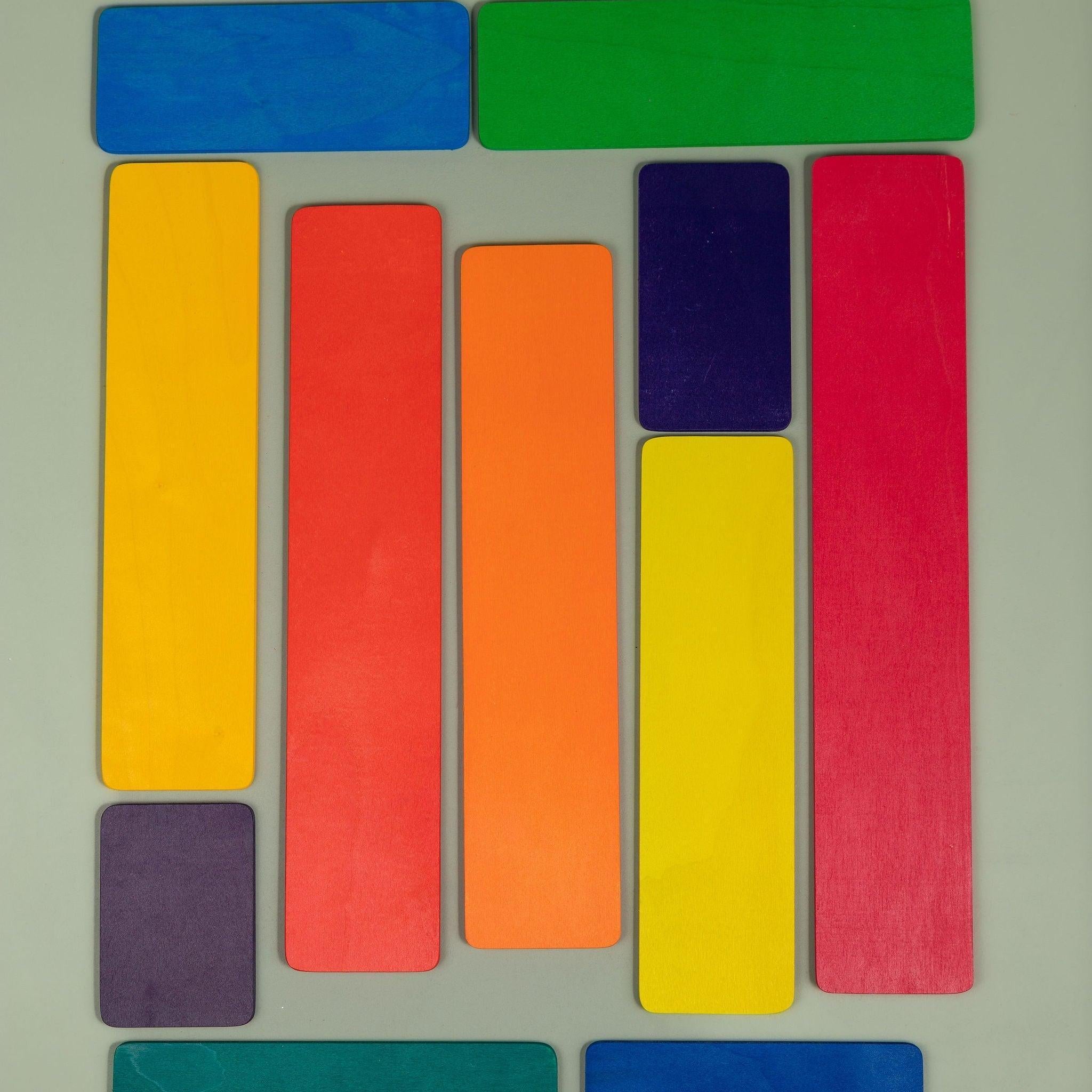 Wooden strip pieces from the building set laid out as a road or fence in imaginative play