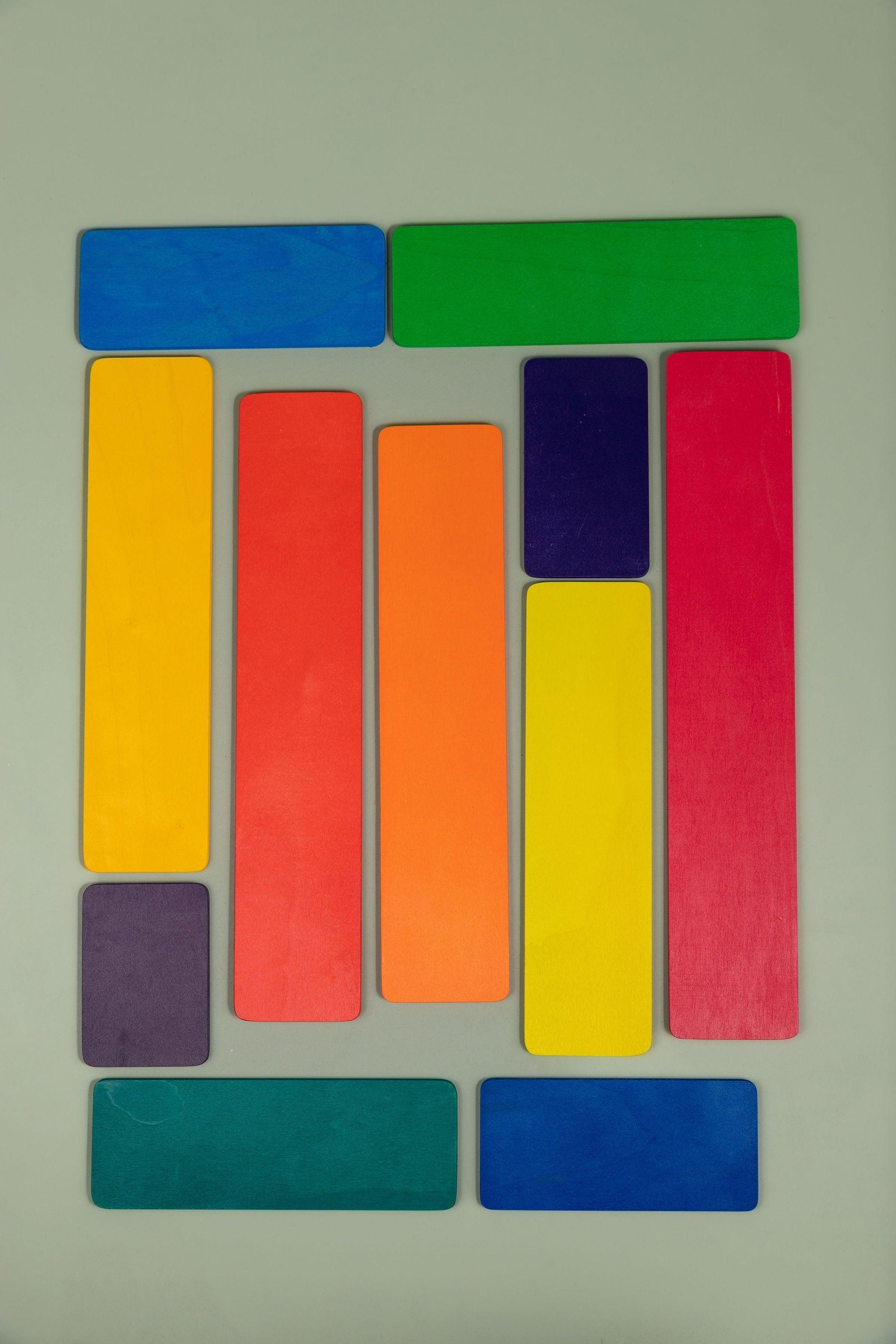 Wooden strip pieces from the building set laid out as a road or fence in imaginative play