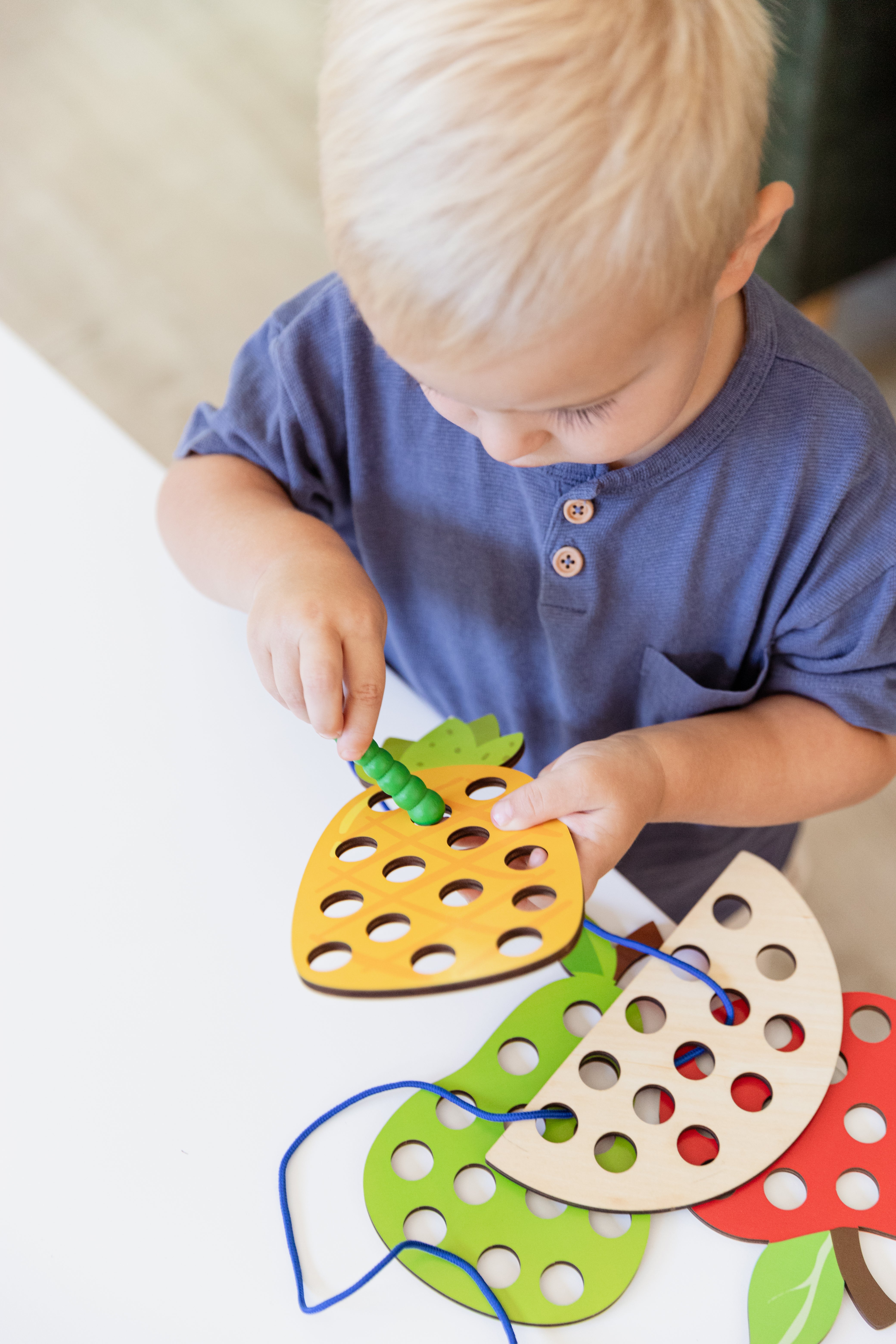 Child using fine motor toys to develop hand strength and coordination