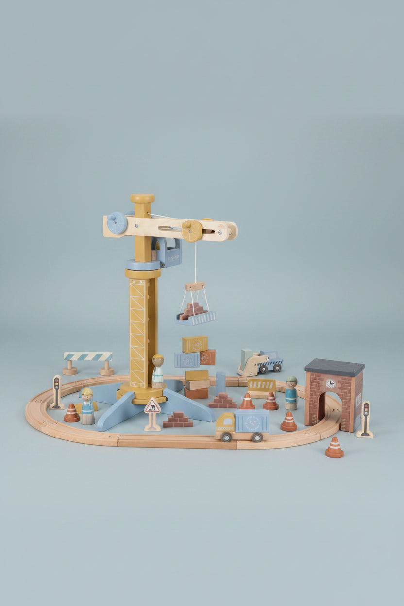 Wooden toy railway set with various pieces on a white background