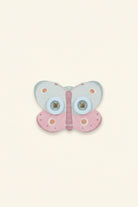 Butterfly-shaped view mastert with pink and blue colors on a beige background