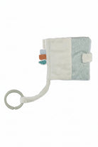 Baby comfort booklet with rattle and soft textures on a white background
