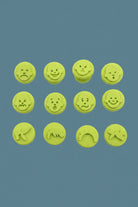 Emotion face stampers used with colourful paint on paper for arts and crafts activity.
