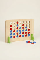 A wooden Connect-four game board with red and blue discs, supported by green triangular stands on a white background.