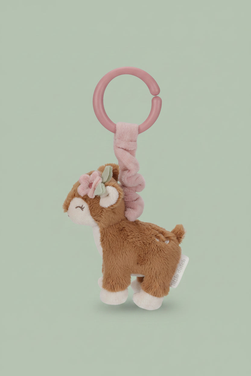 Plush deer toy with pink rattle on a white background