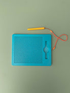 Close-up of magnetic bead pad surface showing raised dots - sensory tactile drawing board for children