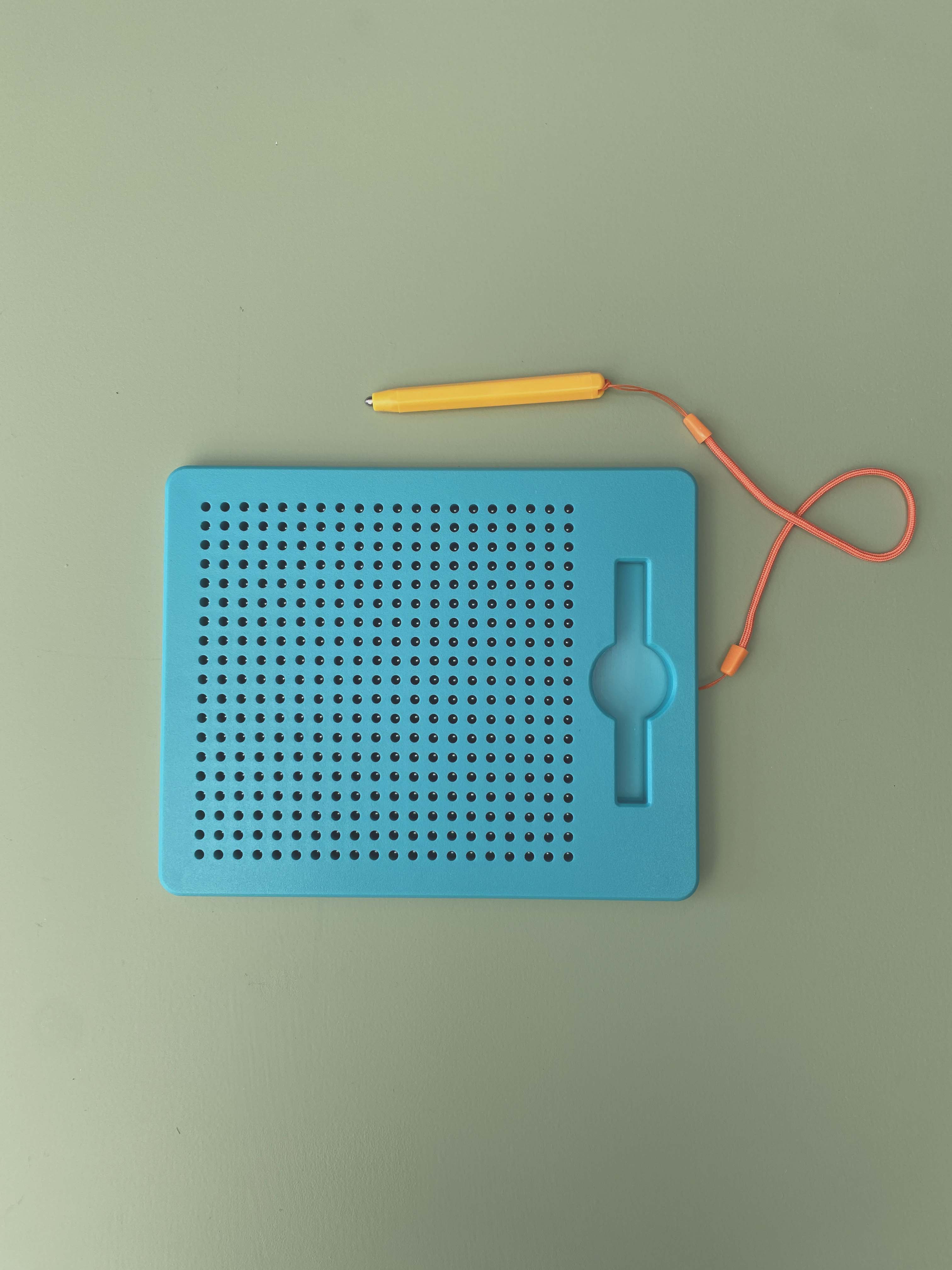 Close-up of magnetic bead pad surface showing raised dots - sensory tactile drawing board for children