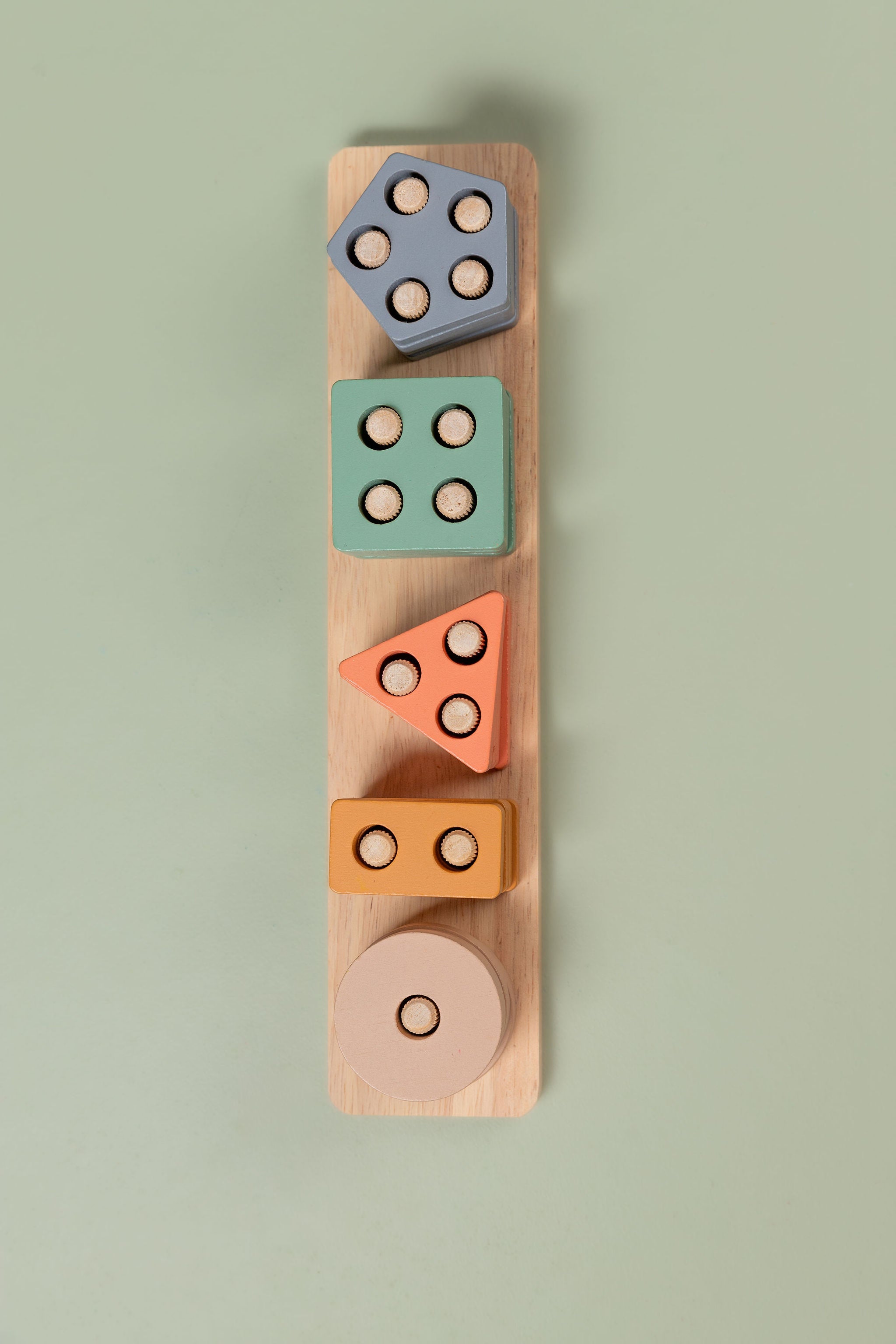 Pastel wooden geometric shape sorter with vertical rods and colourful stacked shapes 