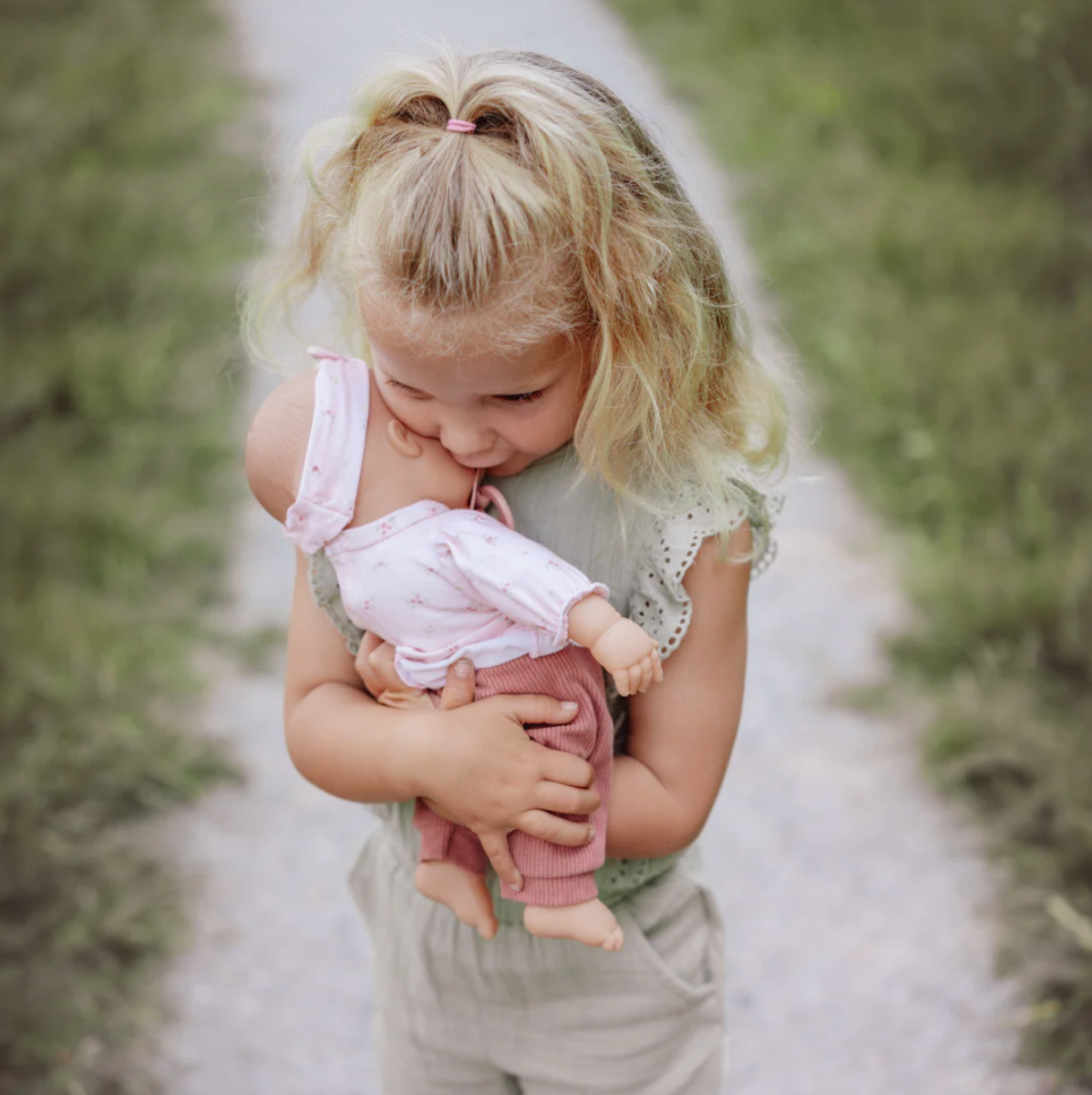 Soft bodied baby doll Lily with pink outfit