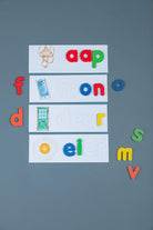 Kids building words with wooden alphabet letters