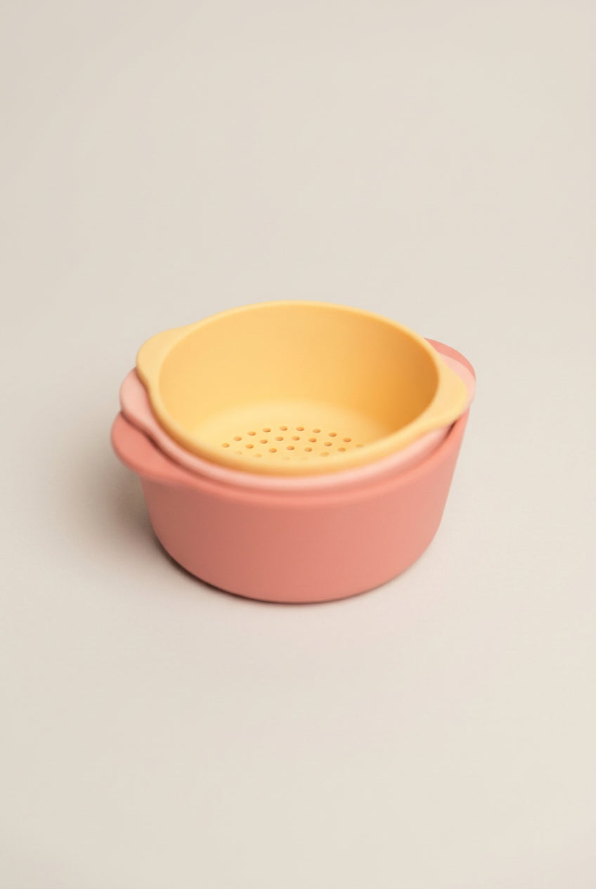 Two-toned pink and yellow plastic container on a white background