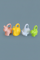 Four animal-shaped watering cans in pink, yellow, light blue, and green, arranged in a row on a plain white background.