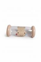 A clear plastic baby toy tunnel with beige circular ends and a cute cartoon bear printed in the center, shown on a plain white background.