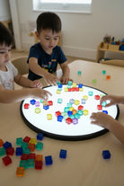 children playing with blocks on lightbox