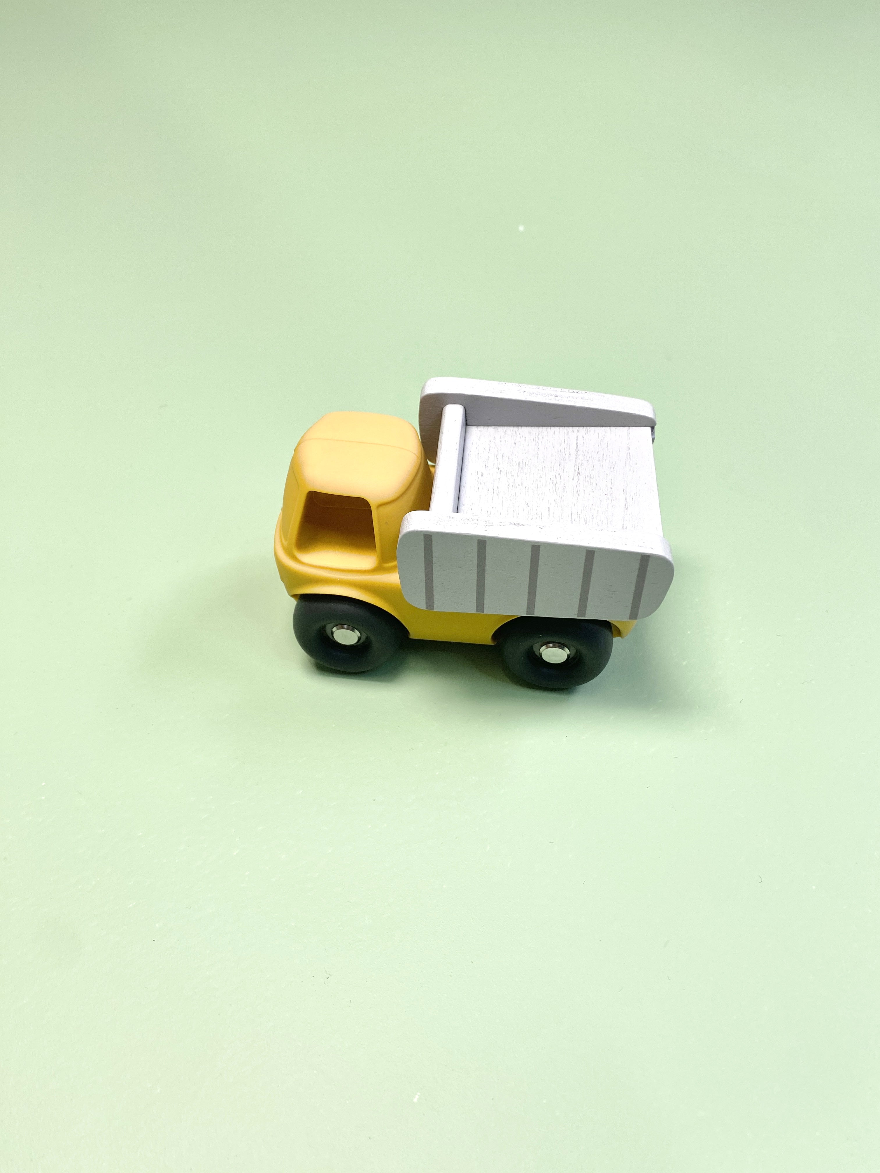 Toy dump truck on a light green background