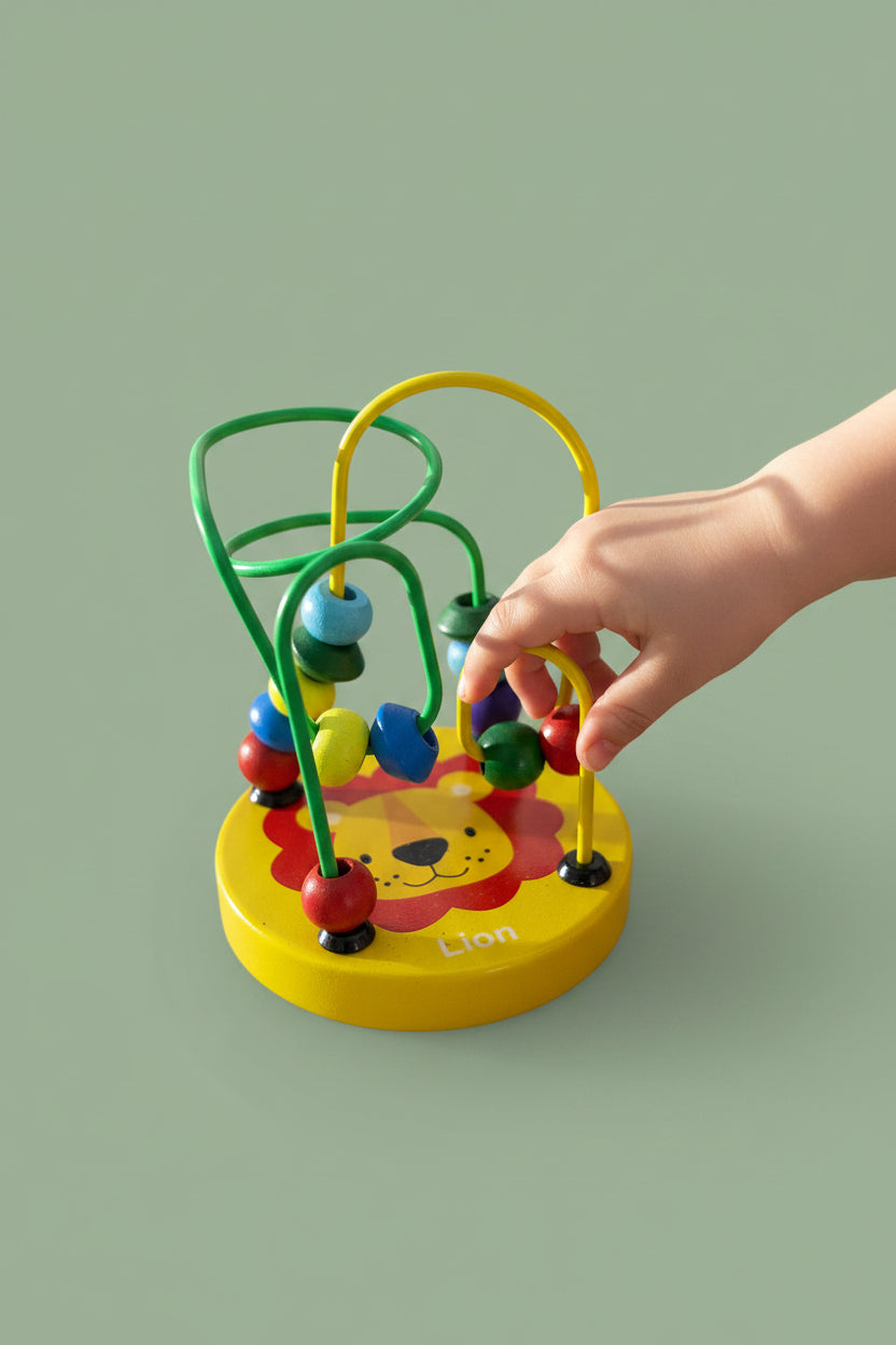 Colorful lion-shaped bead maze toy on a wooden surface