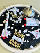 Moonlanding sensory set with black rice, astronaut figurines and metal tools for imaginative and sensory play