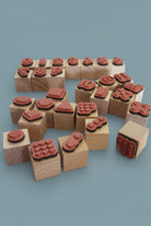 Set of wooden blocks with red stamp-like designs numbers, dots and shapers