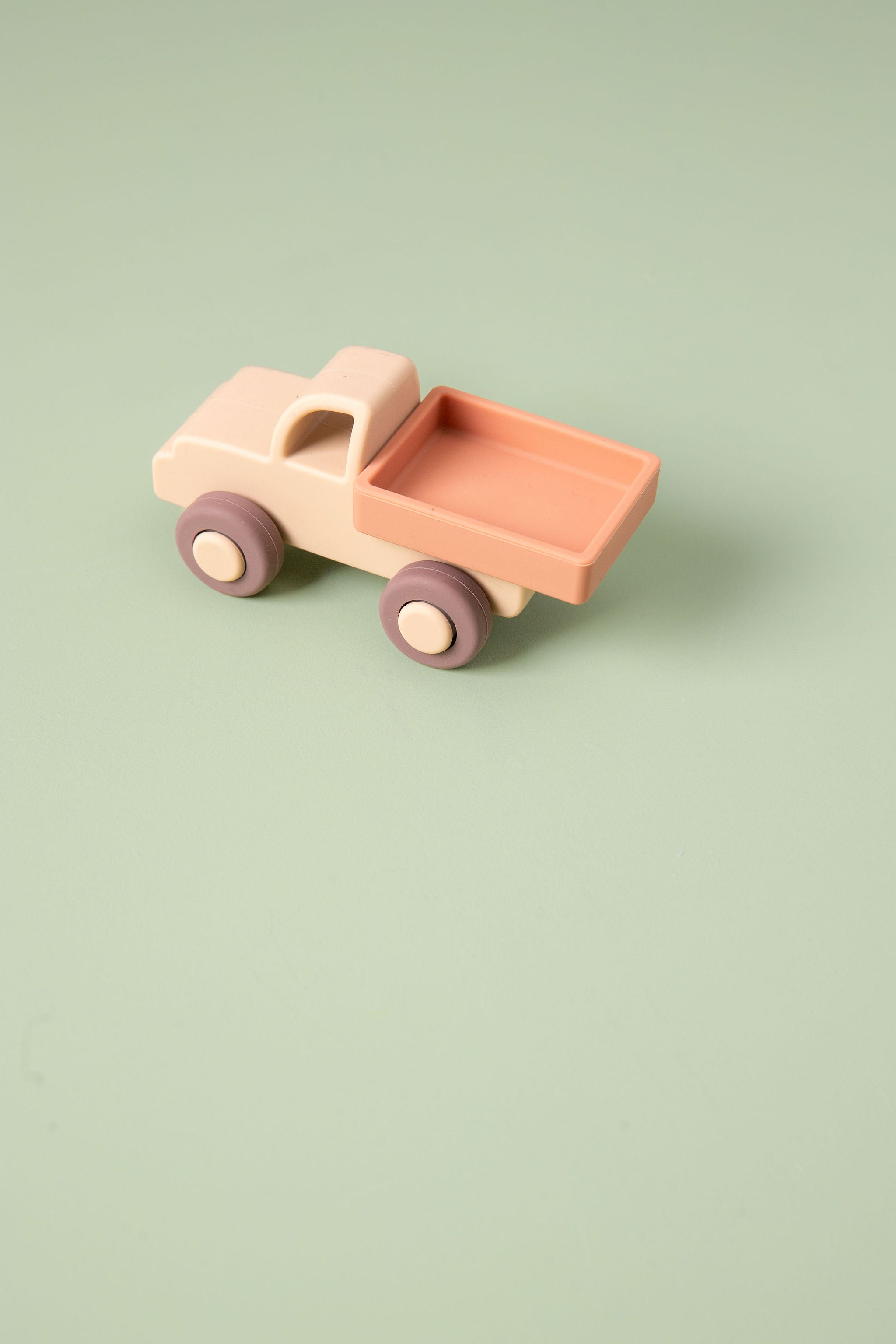 Silicone  toy truck on a light green background