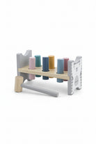 A wooden toy hammer set with a peg rack, shown on a white background with dimension lines indicating 200mm width, 105mm height, and 70mm depth. The set includes a natural wood mallet, pegs in pink, teal, blue, yellow, and purple, and a bear-themed side panel.