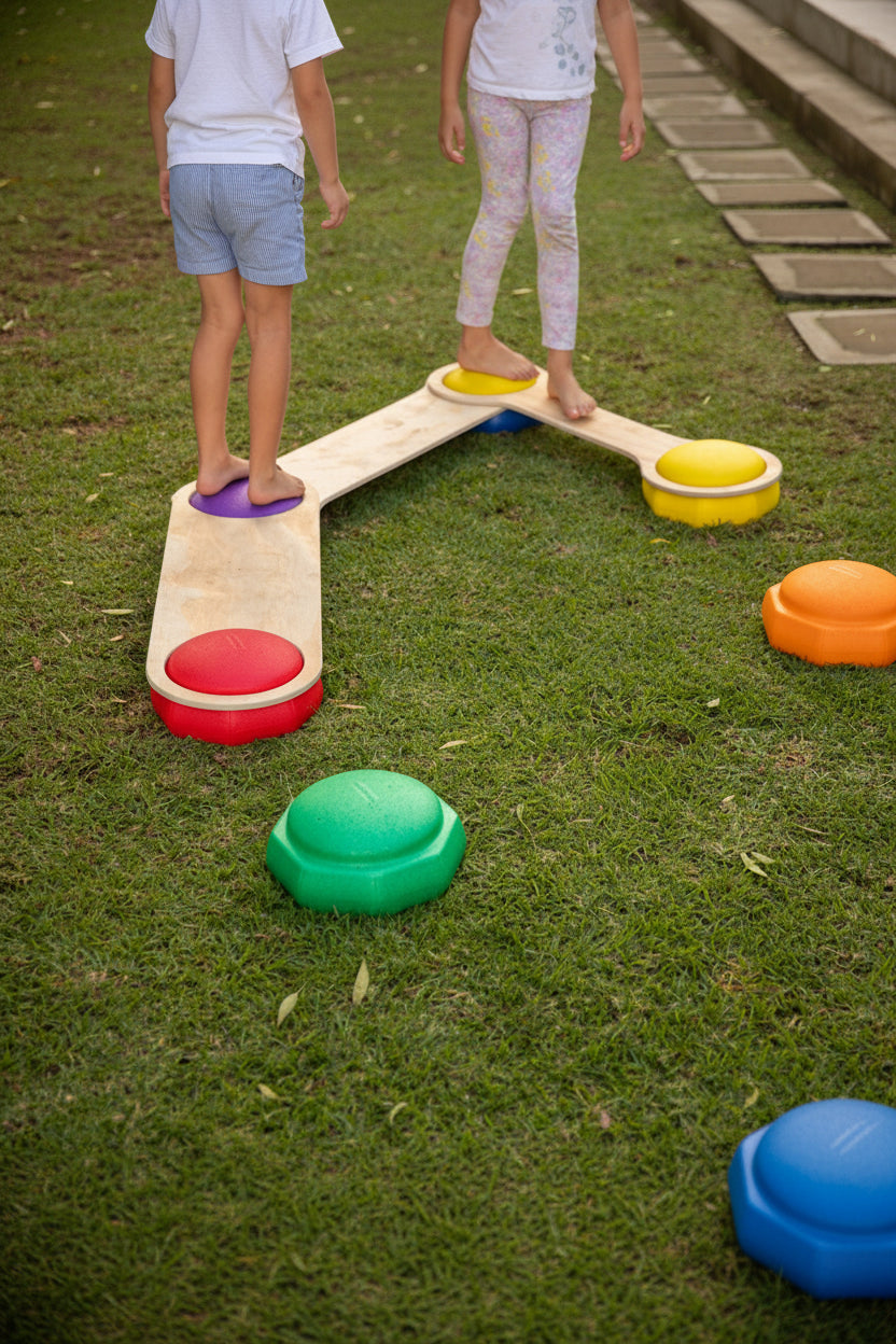 Set of colourful rainbow stepping stones arranged on a wooden floor for children's balance play