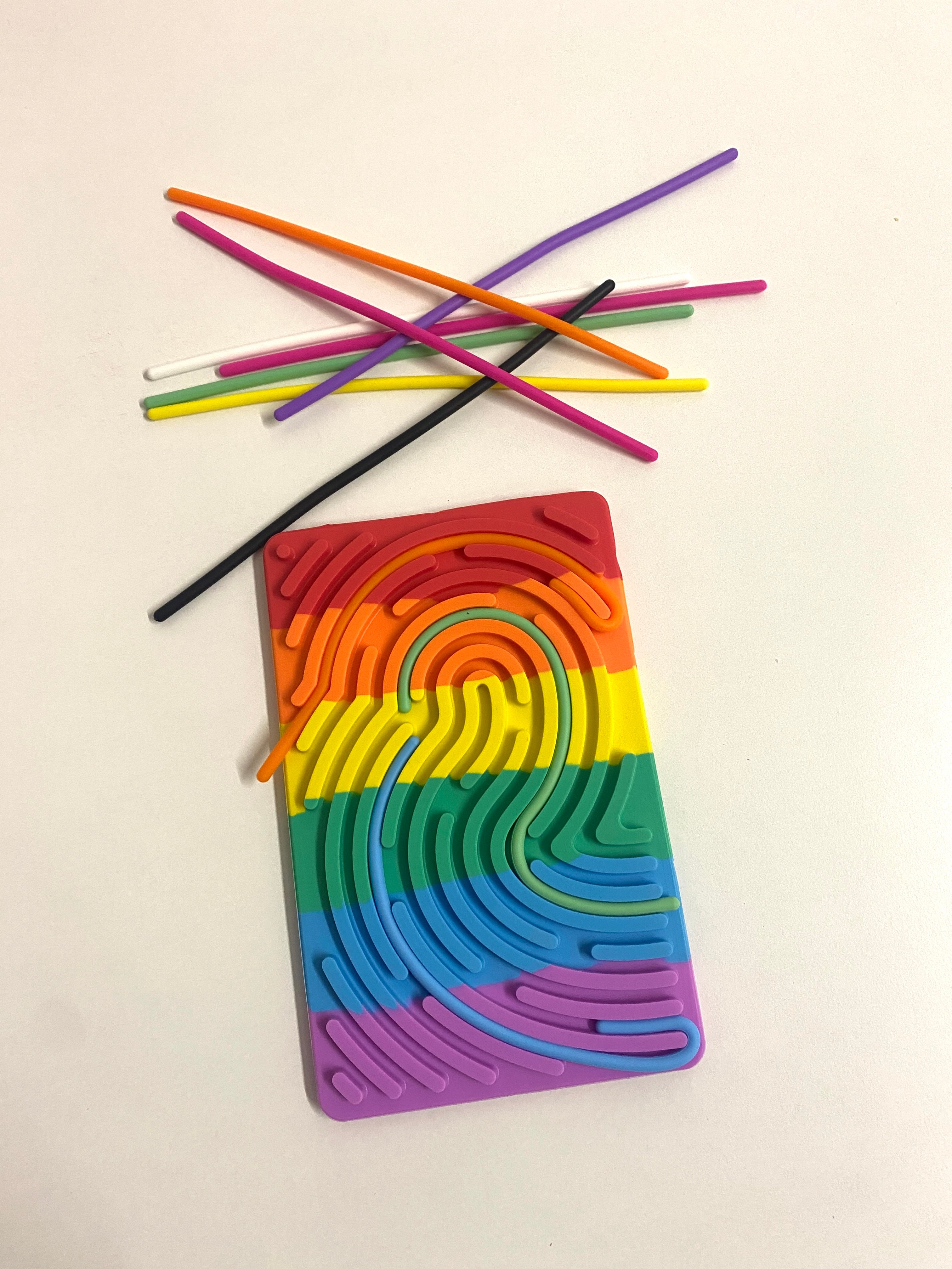 Colorful silicone straw holder with straws on a light background