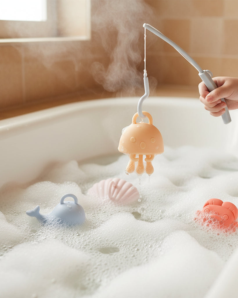 Splashy Seas silicone fishing bath toy set showing blue whale, coral crab, pink seashell, sandy jellyfish and fishing rod with dimensions on white background