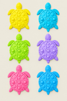 Six turtle-shaped silicone stepping stones  in yellow, light blue, lime green, purple, pink, and light blue, arranged on a light wood surface.