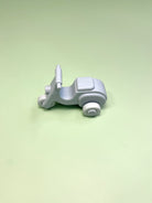 Small blue  silicone  vespa  on a light green background